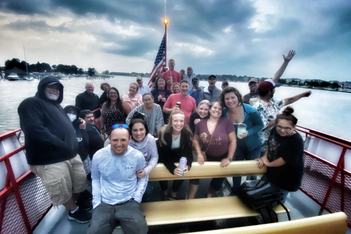 Salima Ikram et al. standing in front of a boat